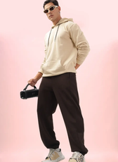 Stylish men's joggers from the 'Louis' sewing pattern, shown in a casual outfit. Features a relaxed fit and elastic waistband.