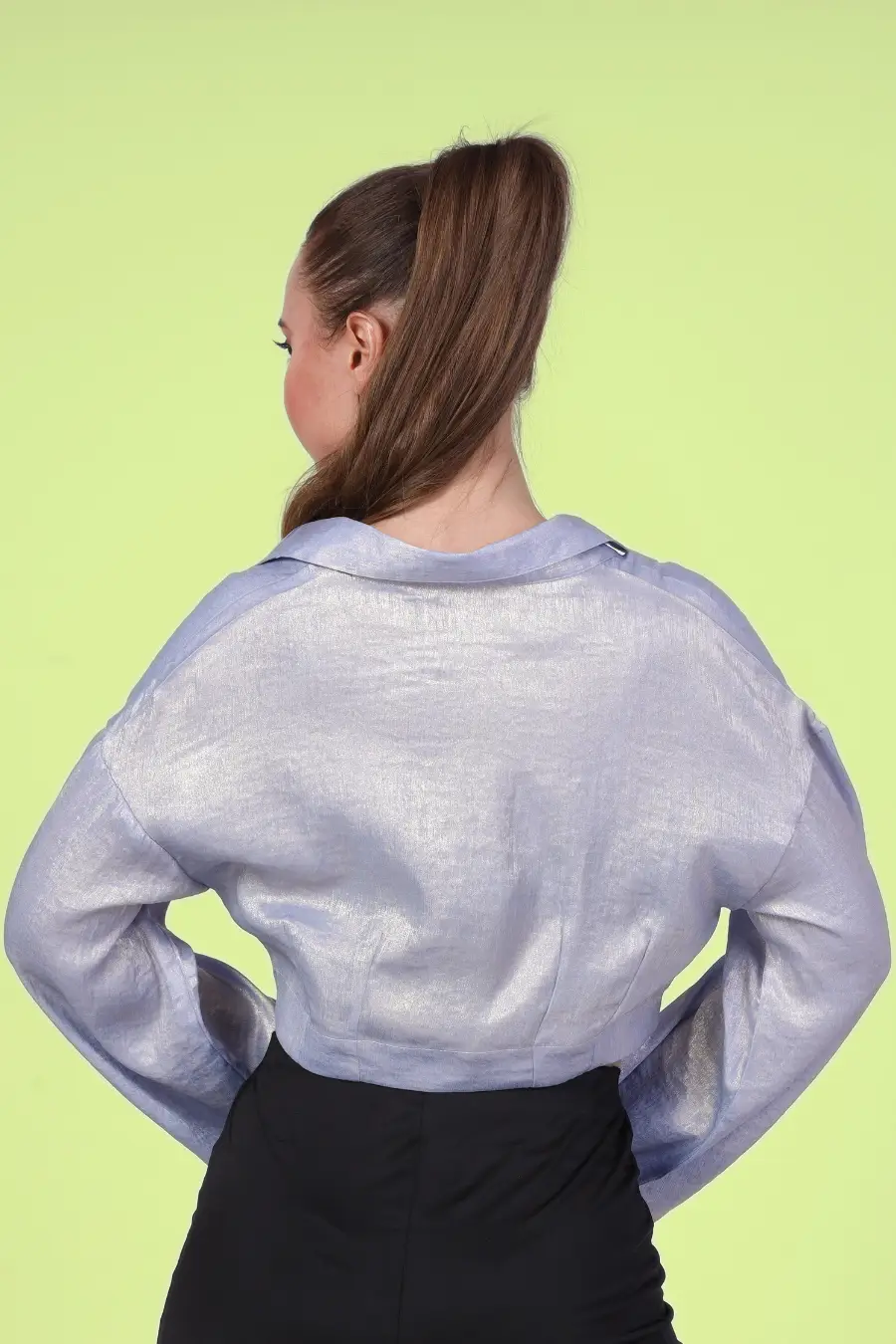 Back view of a model wearing a twist front shirt with full length sleeves sewed with Winslet's patterns