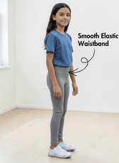 Side view of girl in blue T-shirt and gray leggings with smooth elastic waistband, highlighting Kid's Leggings Sewing Pattern Avery