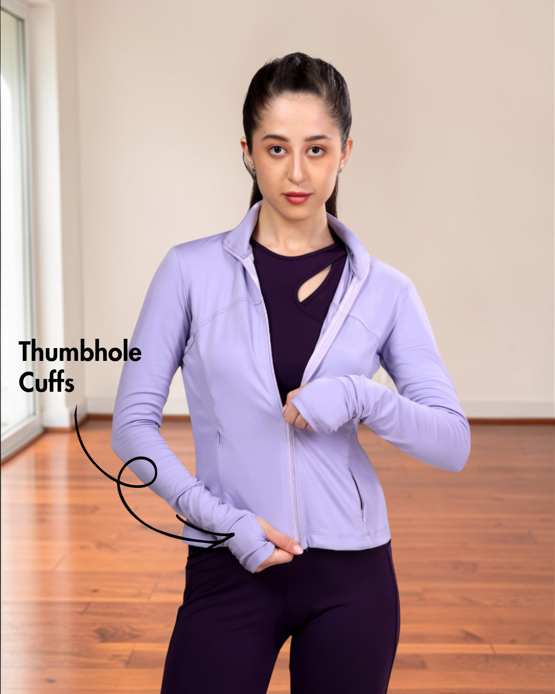 Woman in purple sports jacket with thumbhole cuffs, back view