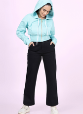 Hoodie Sewing Pattern 'Rue' with hood up. A stylish zip-up hoodie with a cropped fit, front pocket, and ribbed waistband for a trendy casual look.