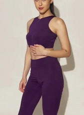 Model wearing purple activewear crop top and leggings