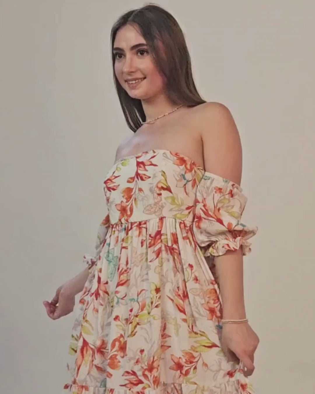 Photo of woman wearing off shoulder floral dress with ruffled sleeves