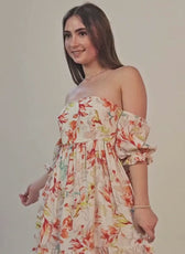 Photo of woman wearing off shoulder floral dress with ruffled sleeves