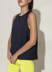 Model wearing black sleeveless athletic tank top with yellow shorts