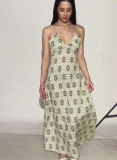 Model wearing a long, sleeveless, printed maxi dress with spaghetti straps