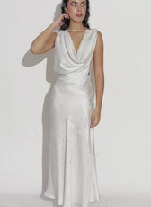 distant shot of model wearing backless cowl neck gown 