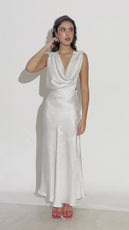 distant shot of model wearing backless cowl neck gown 