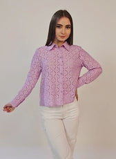 Model wearing pink patterned women's collared shirt with long sleeves and buttoned cuffs, front view