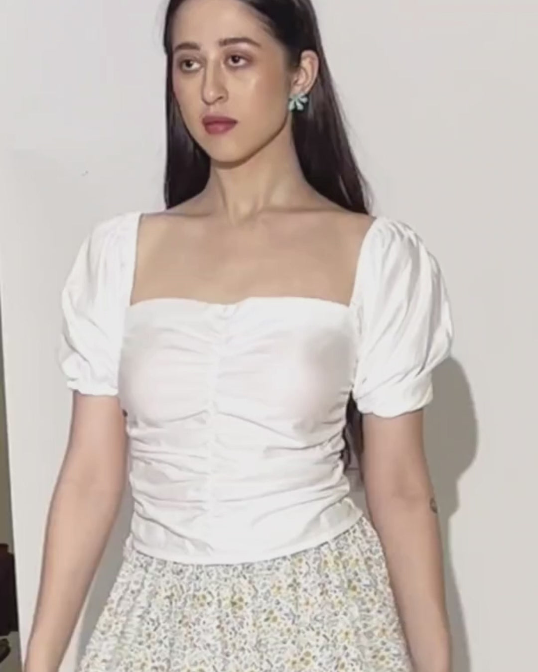 Model wearing women's puff sleeves ruched top 'Sallie' with square neckline and puffed sleeves, styled with patterned skirt