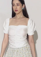Model wearing women's puff sleeves ruched top 'Sallie' with square neckline and puffed sleeves, styled with patterned skirt