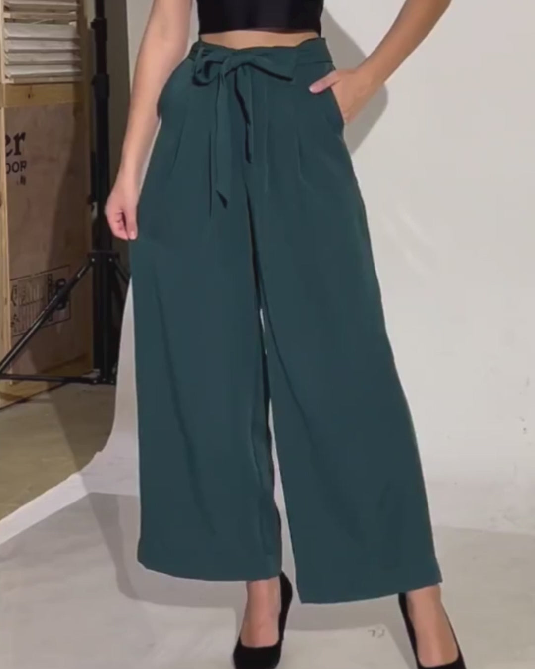 Photo of model wearing wide leg trousers with belt in dark green, sewing pattern 'Margot' for arts and entertainment