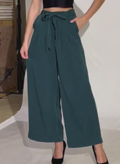 Photo of model wearing wide leg trousers with belt in dark green, sewing pattern 'Margot' for arts and entertainment