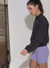 Behind-the-scenes shot of a model wearing the Naomi windbreaker during a photoshoot. A stylish and functional outerwear sewing pattern.