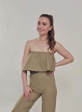 model wearing strapless jumpsuit with ruffled overlay