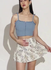 Video of Model wearing floral flounce skirt with ruffled hem and fitted waist