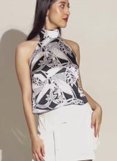 Model wearing sleeveless halter top with high neckline from sewing pattern