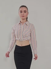 Model wearing a belted cropped shirt with long sleeves, classic point collar, and button-down front