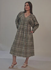Video of a model posing in a long sleeves midi dress sewed with WInslet's patterns