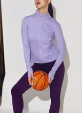 Model wearing lavender sports jacket with high collar, full zip, and activewear style