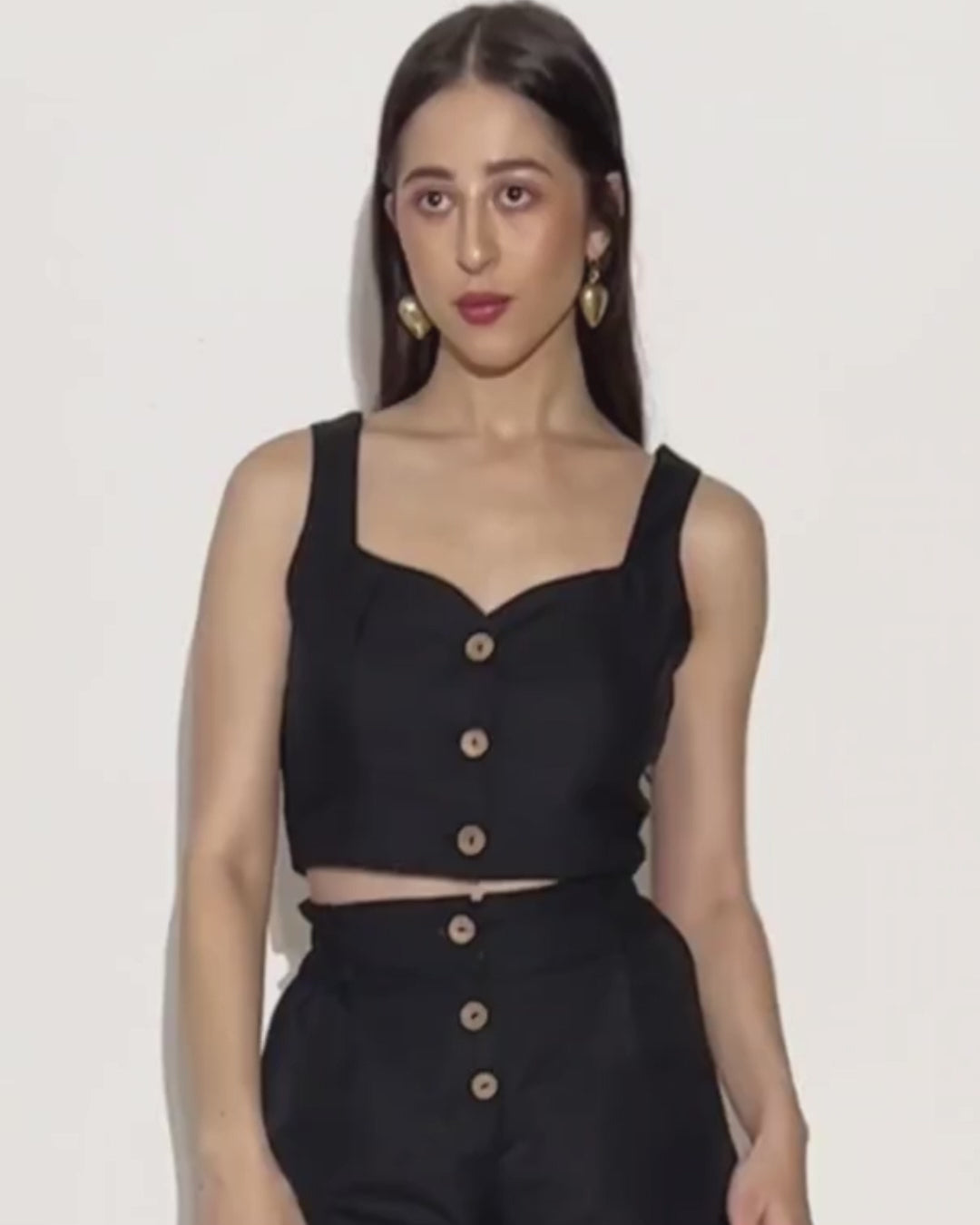 Model wearing black crop top and high waisted shorts Harper sewing pattern