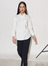 Model wearing a white women's sewing pattern shirt with collar, long sleeves, and front pocket