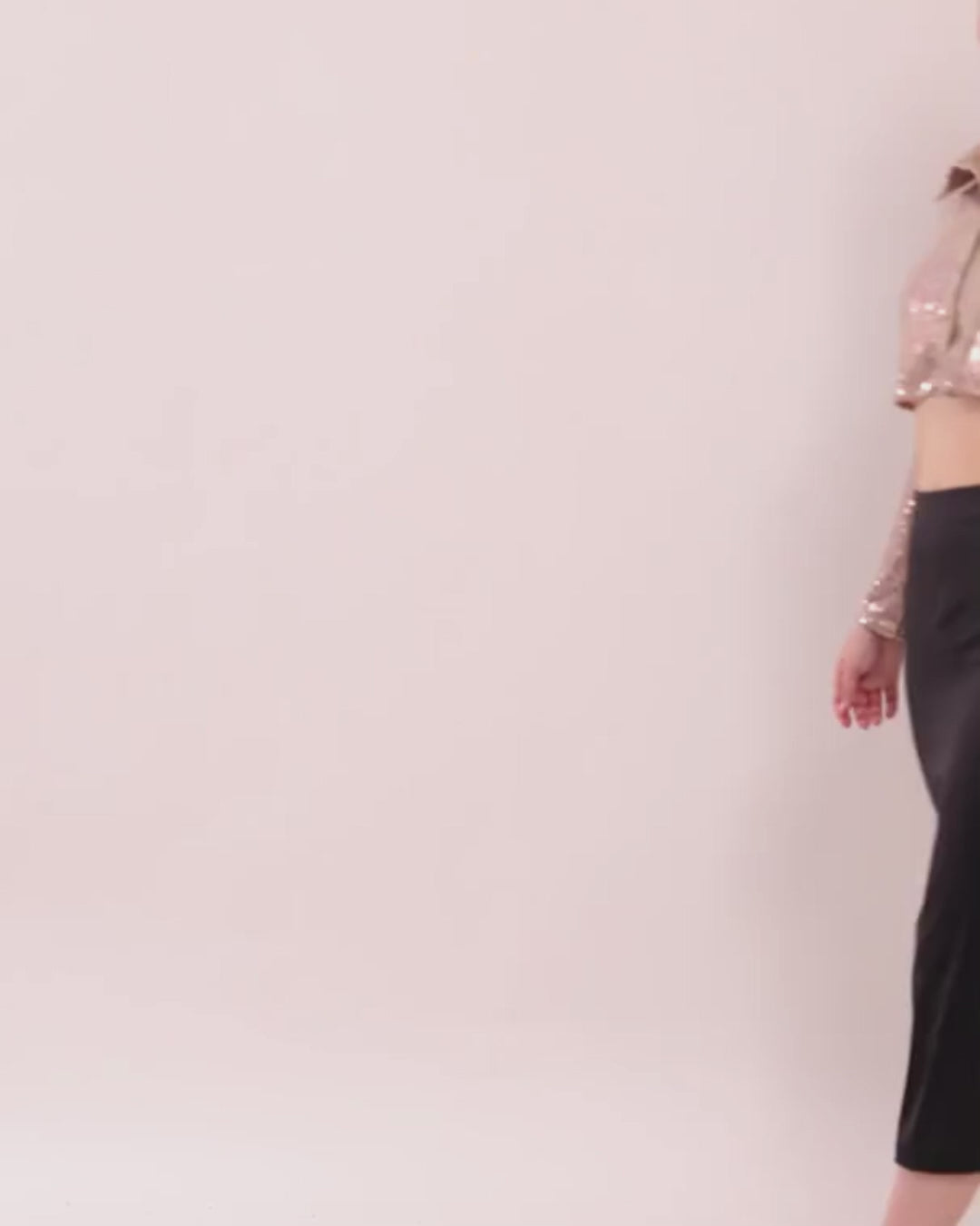 Model wearing cropped women's shirt Myrtle with sequin top and black pants, fashion style