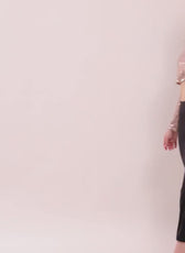 Model wearing cropped women's shirt Myrtle with sequin top and black pants, fashion style