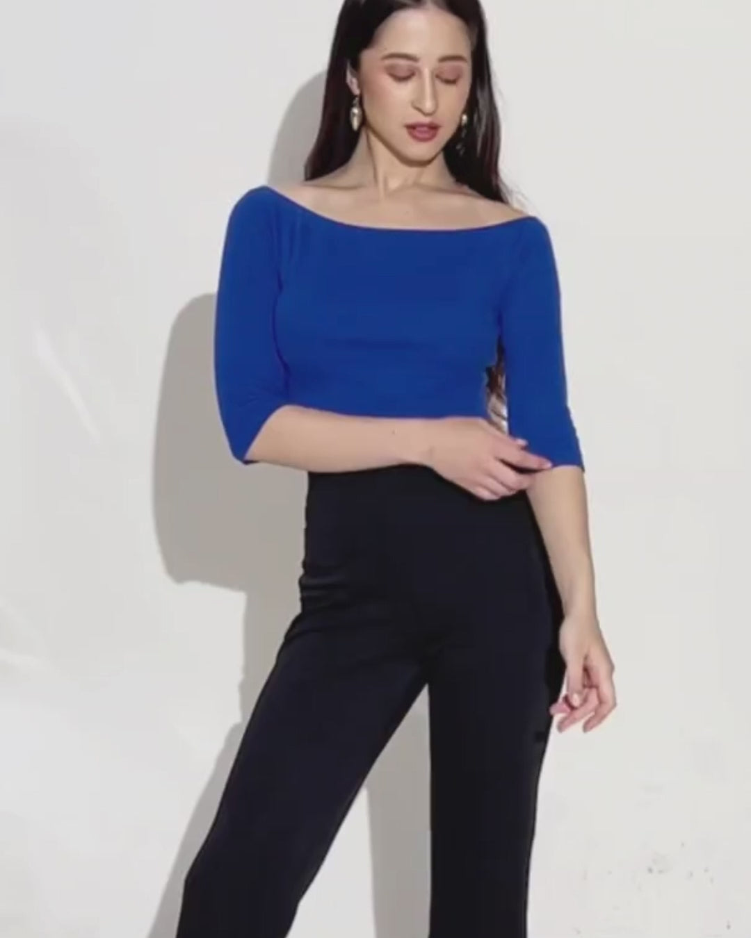 Model wearing blue off shoulder top with 3/4 sleeves