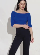 Model wearing blue off shoulder top with 3/4 sleeves