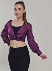Woman modeling purple satin crop top with long sleeves and twist front design