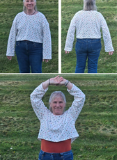 Customer wearing a white Selena sweatshirt with colorful polka dots, showing front, back, and movement flexibility of the design.